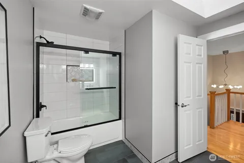 a bathroom with a glass shower door