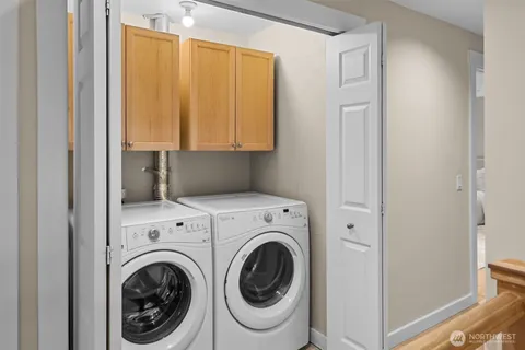 a view of a hallway with washer and dryer