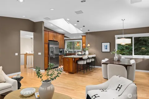 a living room with fireplace furniture and a large window