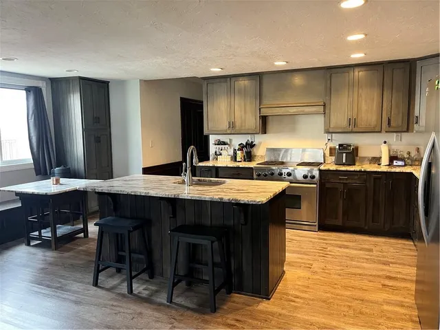 a kitchen with a sink cabinets and wooden floor
