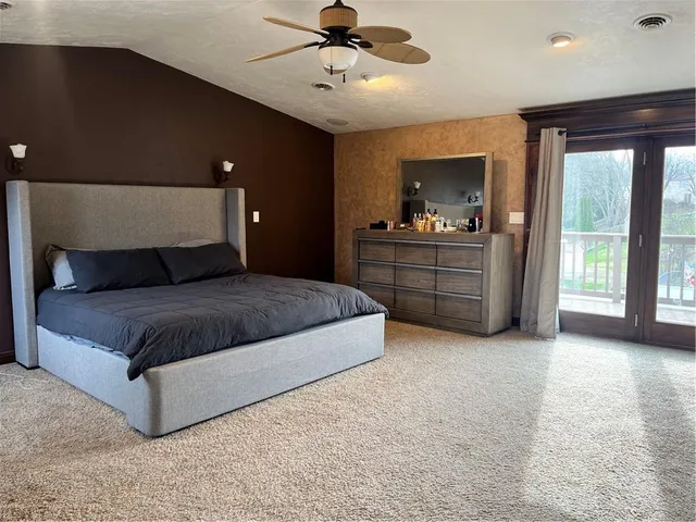 a spacious bedroom with a large bed and a window