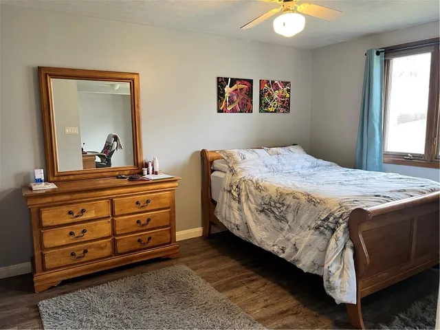 a bedroom with a bed and a dresser in it