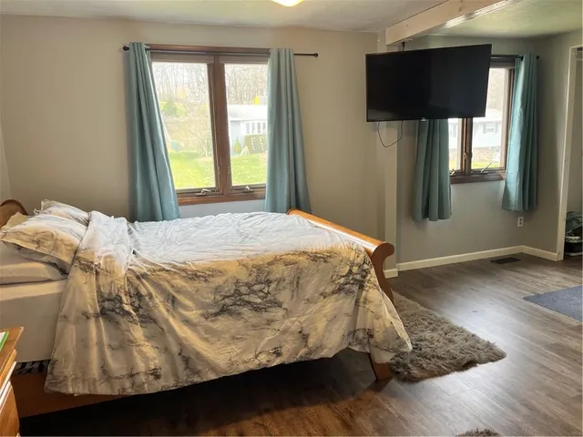 a bed sitting in a bedroom next to a window