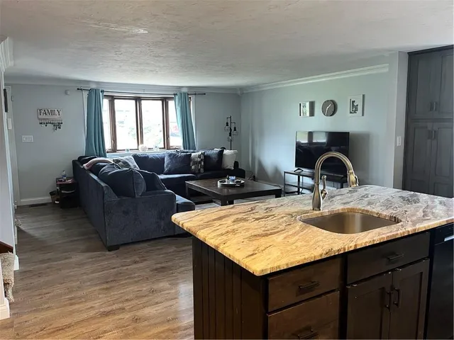 a living room with granite countertop furniture and a sink