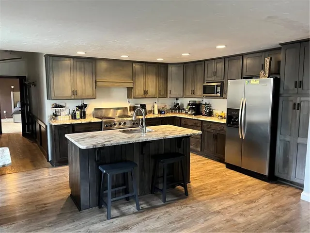 a kitchen with kitchen island a sink table and chairs