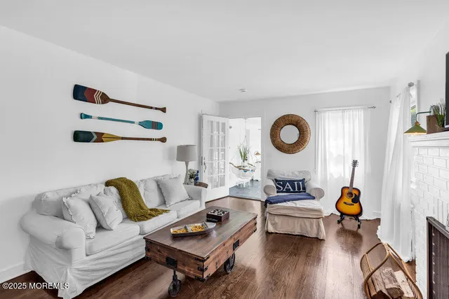 a living room with furniture a rug and a window