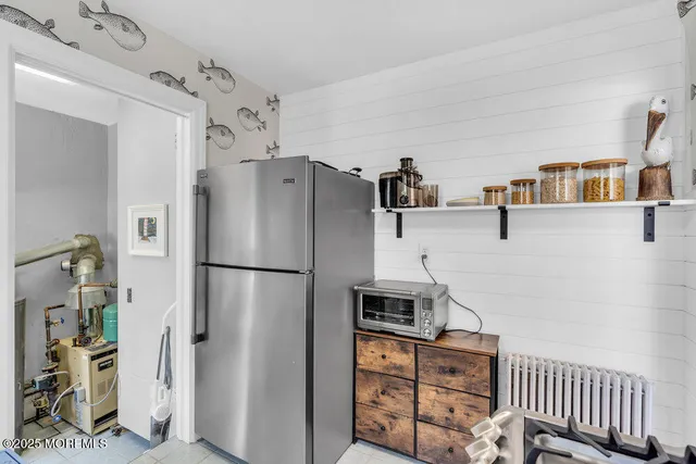 a white refrigerator freezer and a stove sitting inside of a kitchen
