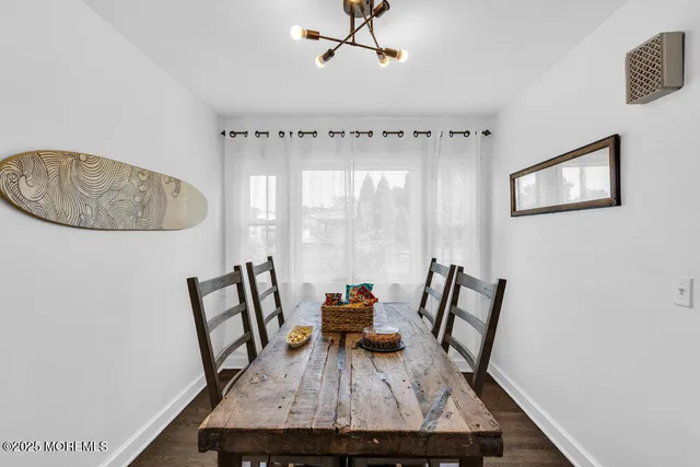 a view of a room with furniture and wooden floor
