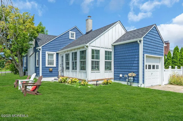 a front view of a house with garden and porch