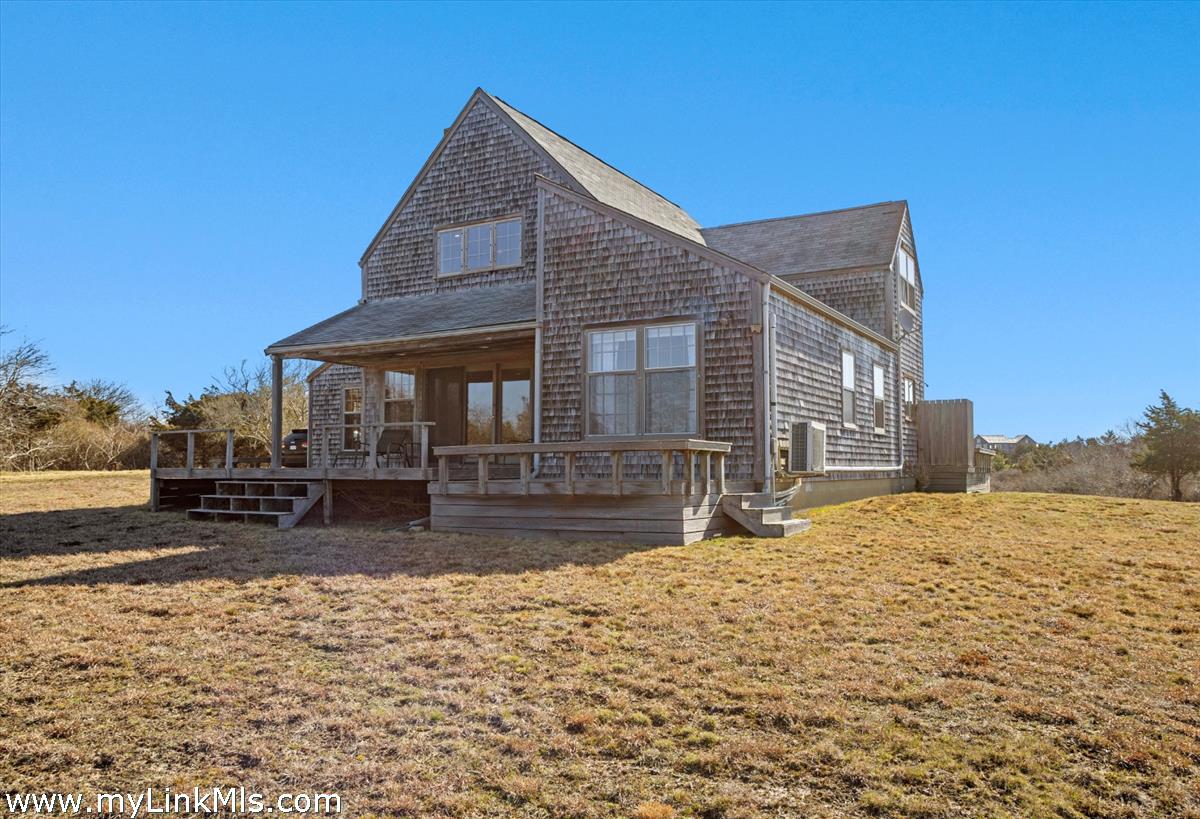 13 Eat Fire Spring Road Nantucket, MA 02554 - Photo 37 of 43 a front view of a house with a yard