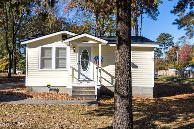 a front view of a house with garden