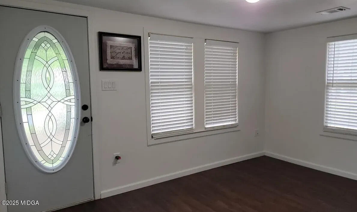 4501 Massey Road Macon, GA 31206 - Photo 4 of 11 an empty room with window and mirror
