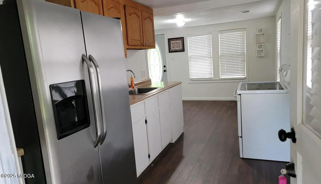 4501 Massey Road Macon, GA 31206 - Photo 5 of 11 a kitchen with stainless steel appliances a refrigerator a sink a stove and cabinets