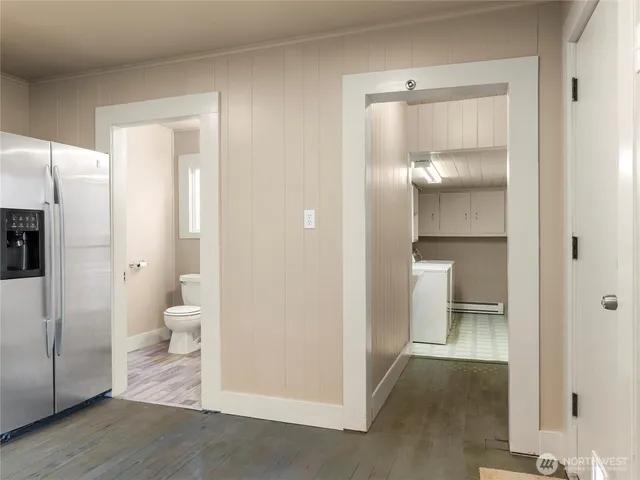 a view of a backyard with plants and large tree