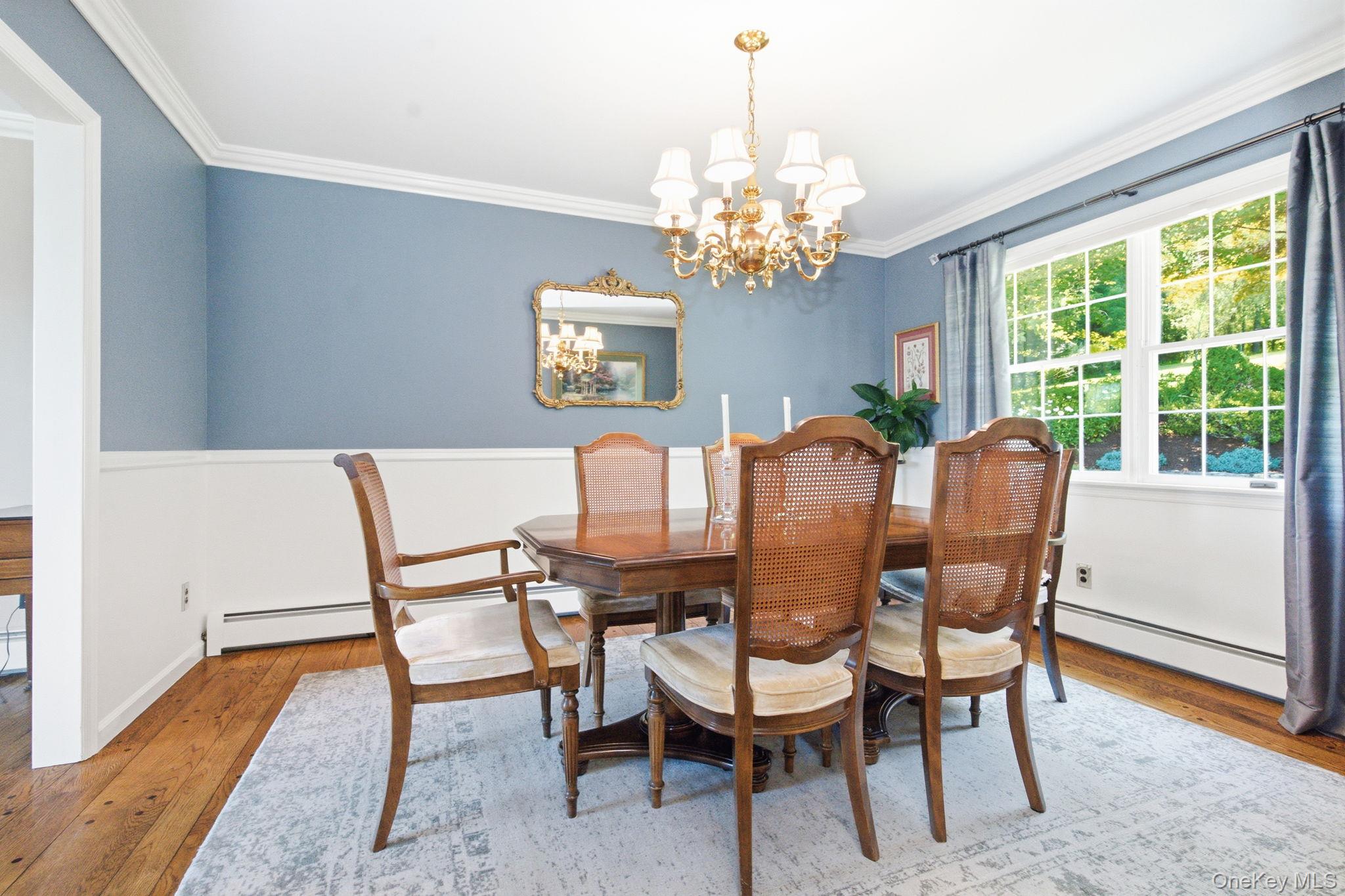 32 Bedell Road Katonah, NY 10536 - Photo 8 of 49 Crisp white wainscoting and a chandelier complete the formal dining room.