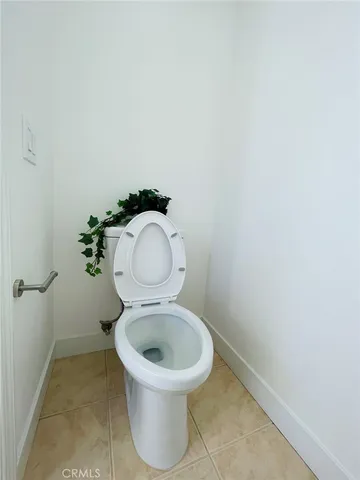 a white toilet sitting in a bathroom