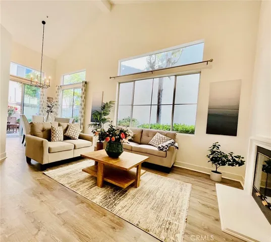 a living room with furniture large window and a flat screen tv