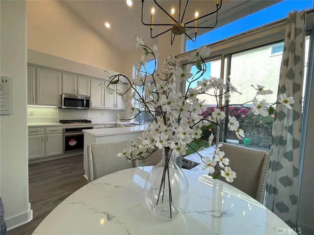a kitchen with a table chairs and microwave