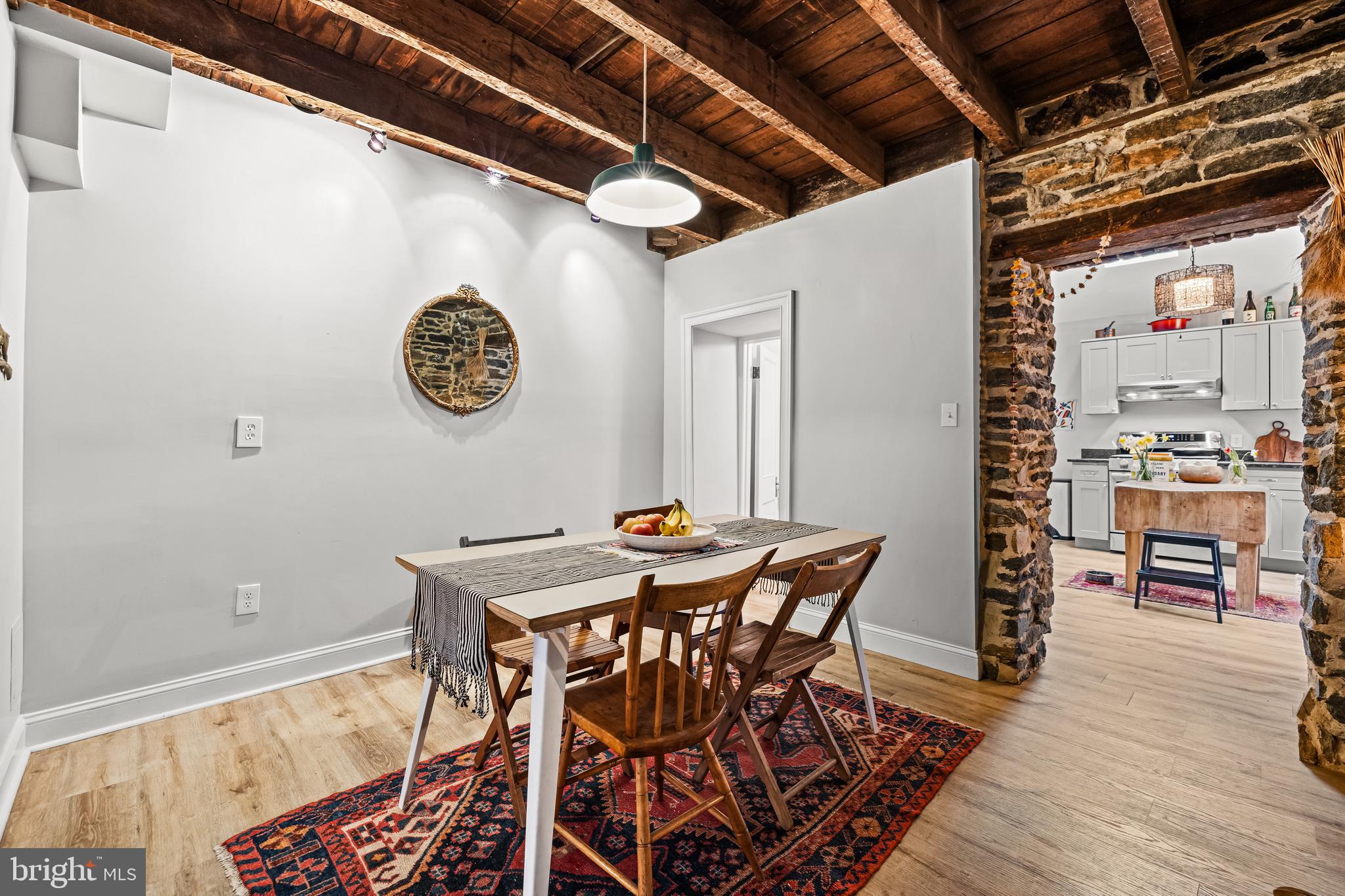 1428 Mill Race Road Baltimore, MD 21211 - Photo 16 of 49 a view of a dining room with furniture and wooden floor