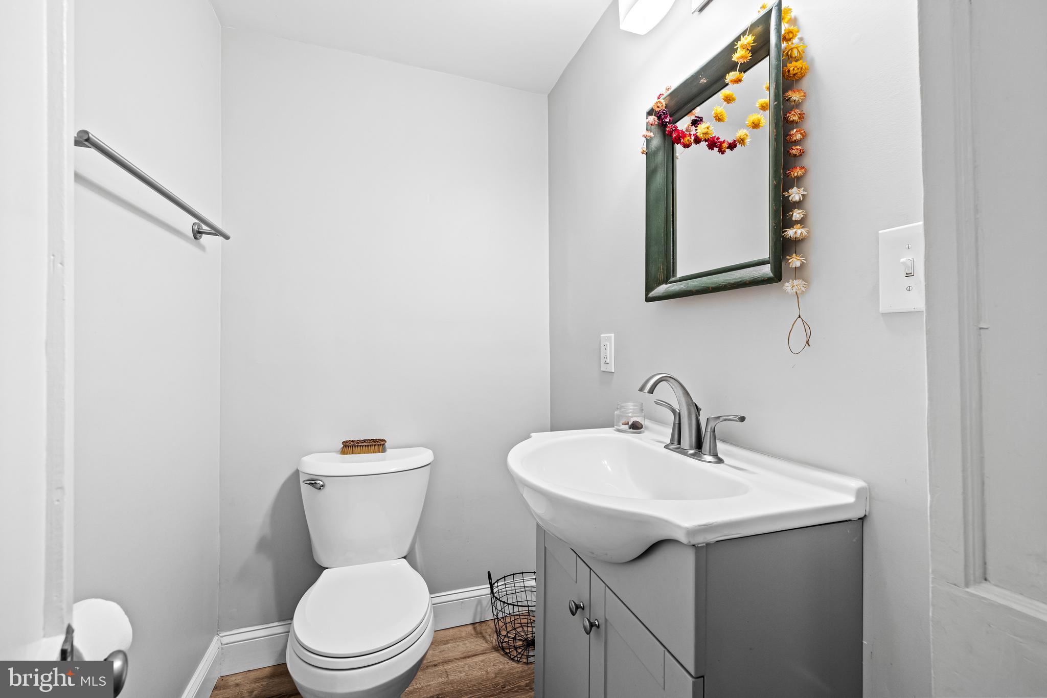 1428 Mill Race Road Baltimore, MD 21211 - Photo 19 of 49 a bathroom with a toilet sink and mirror