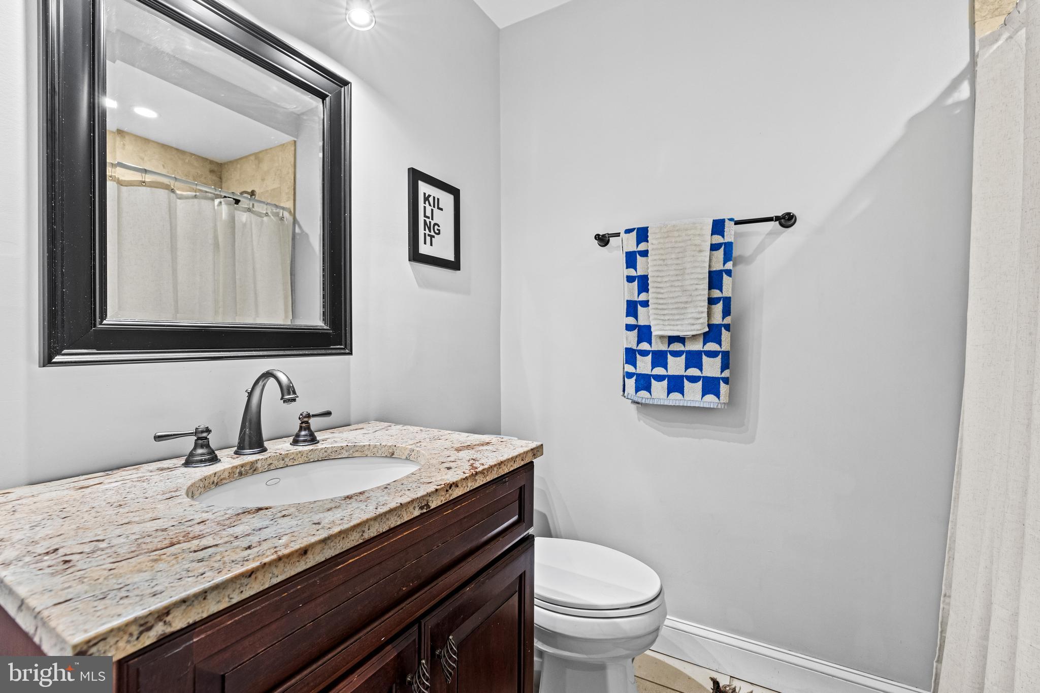 1428 Mill Race Road Baltimore, MD 21211 - Photo 31 of 49 a bathroom with a granite countertop sink and a toilet