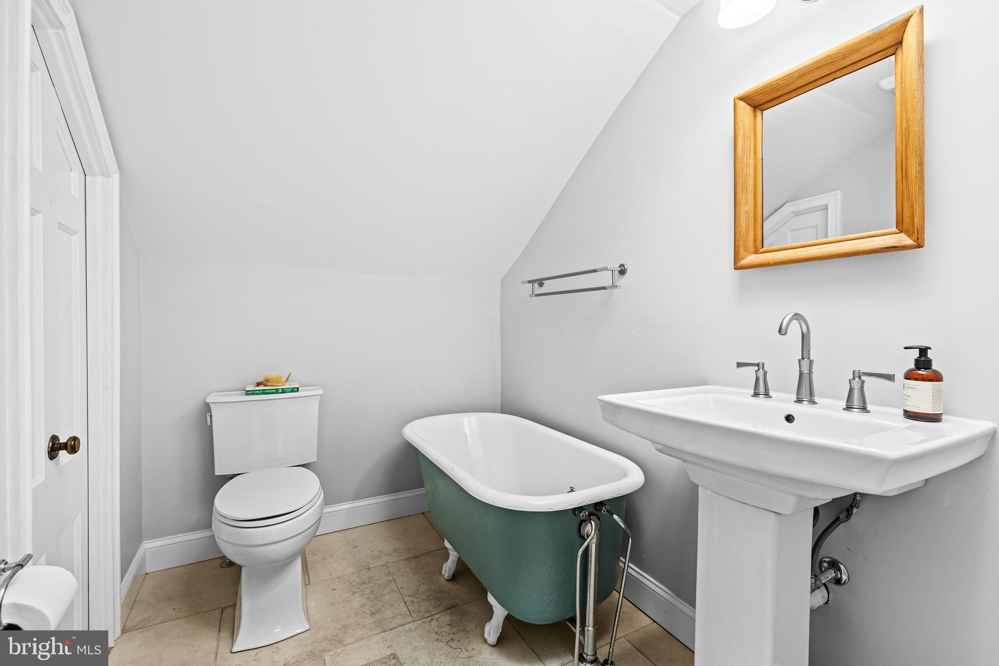 1428 Mill Race Road Baltimore, MD 21211 - Photo 45 of 49 a bathroom with a toilet a sink and a mirror