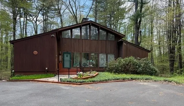 a front view of a house with garden