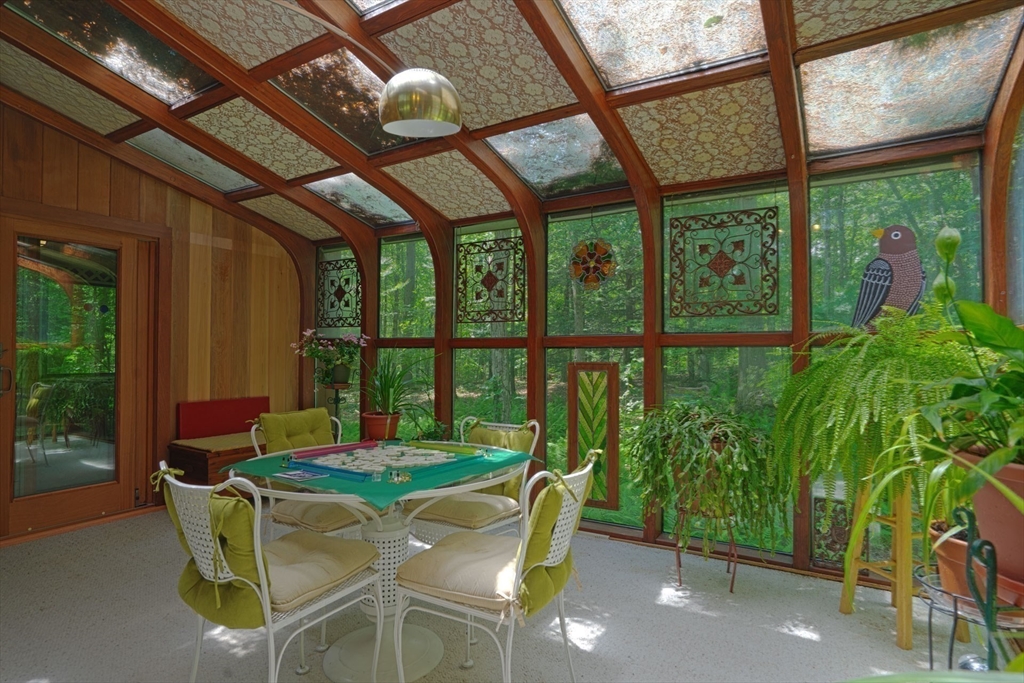 17 Juniper Lane Amherst, MA 01002 - Photo 12 of 42 a dining room with furniture a chandelier and a large window