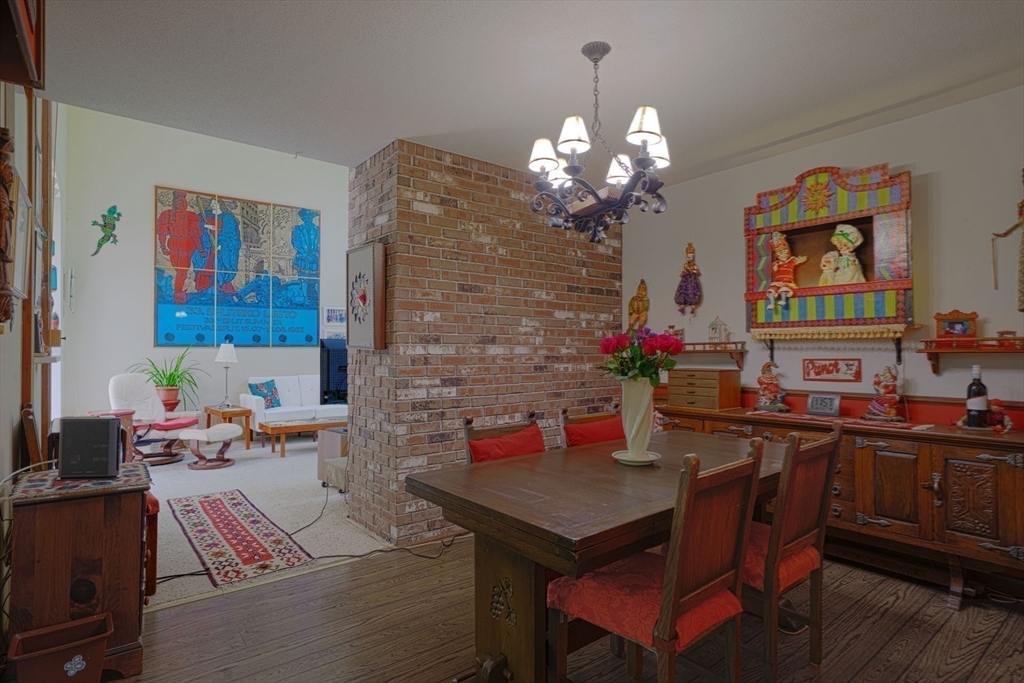 17 Juniper Lane Amherst, MA 01002 - Photo 13 of 42 a view of a dining room with furniture a chandelier and wooden floor
