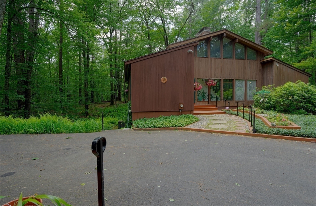 17 Juniper Lane Amherst, MA 01002 - Photo 2 of 42 a front view of a house with a yard and a garage