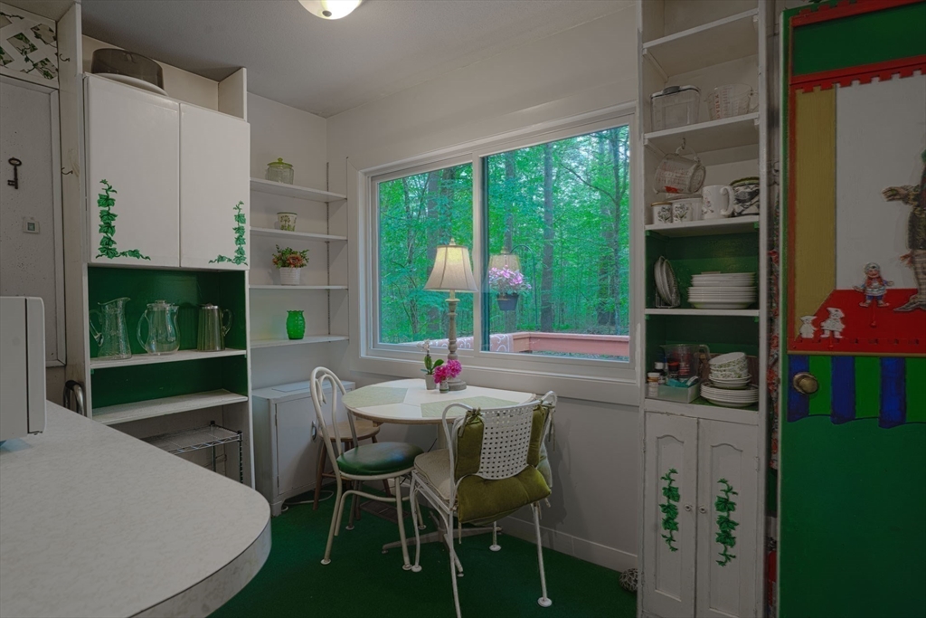 17 Juniper Lane Amherst, MA 01002 - Photo 21 of 42 a dining room with furniture a window and a kitchen view