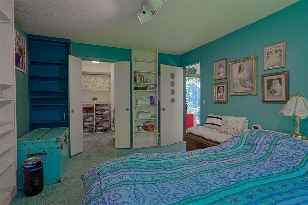 17 Juniper Lane Amherst, MA 01002 - Photo 25 of 42 a bedroom with a bed and a bookshelf