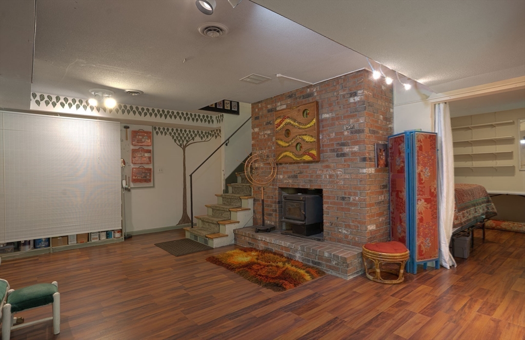 17 Juniper Lane Amherst, MA 01002 - Photo 28 of 42 a living room with hard wood floors and a fireplace