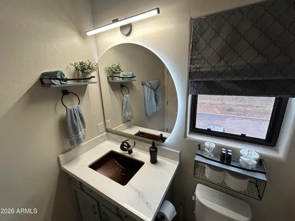 a living room with furniture a flat screen tv and a window