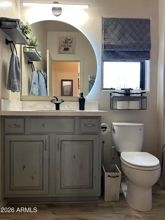 a view of a chair and table in backyard of the house