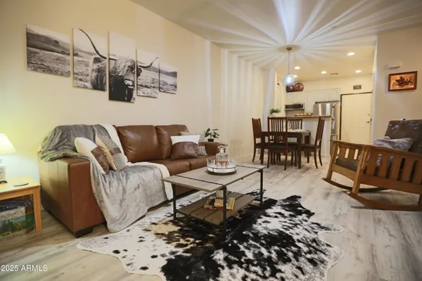 a living room with furniture a flat screen tv and a fireplace