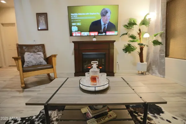 a living room with furniture a fireplace and a flat screen tv