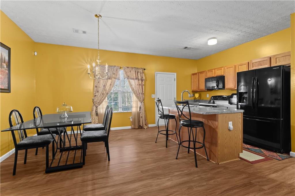 3000 Western Sunset Decatur, GA 30034 - Photo 11 of 37 a kitchen with a table chairs refrigerator and microwave