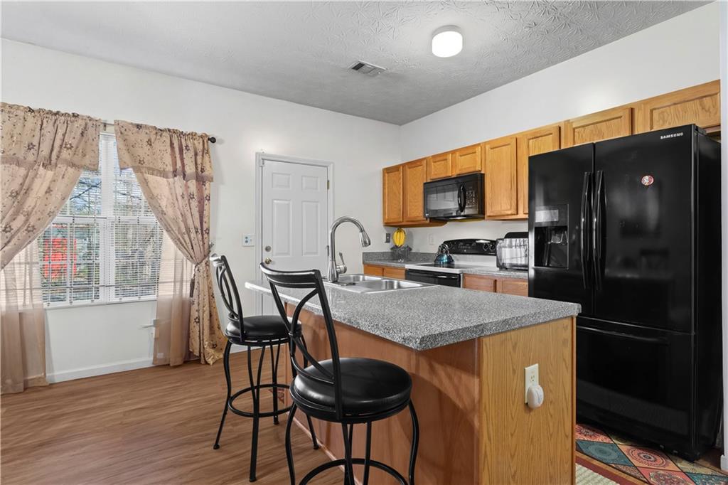 3000 Western Sunset Decatur, GA 30034 - Photo 14 of 37 a kitchen with a table chairs refrigerator and microwave