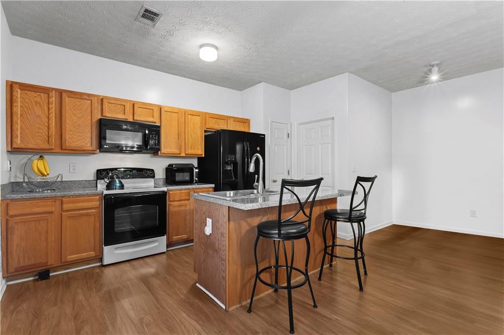 3000 Western Sunset Decatur, GA 30034 - Photo 18 of 37 a kitchen with stainless steel appliances granite countertop a stove a sink a microwave and a refrigerator