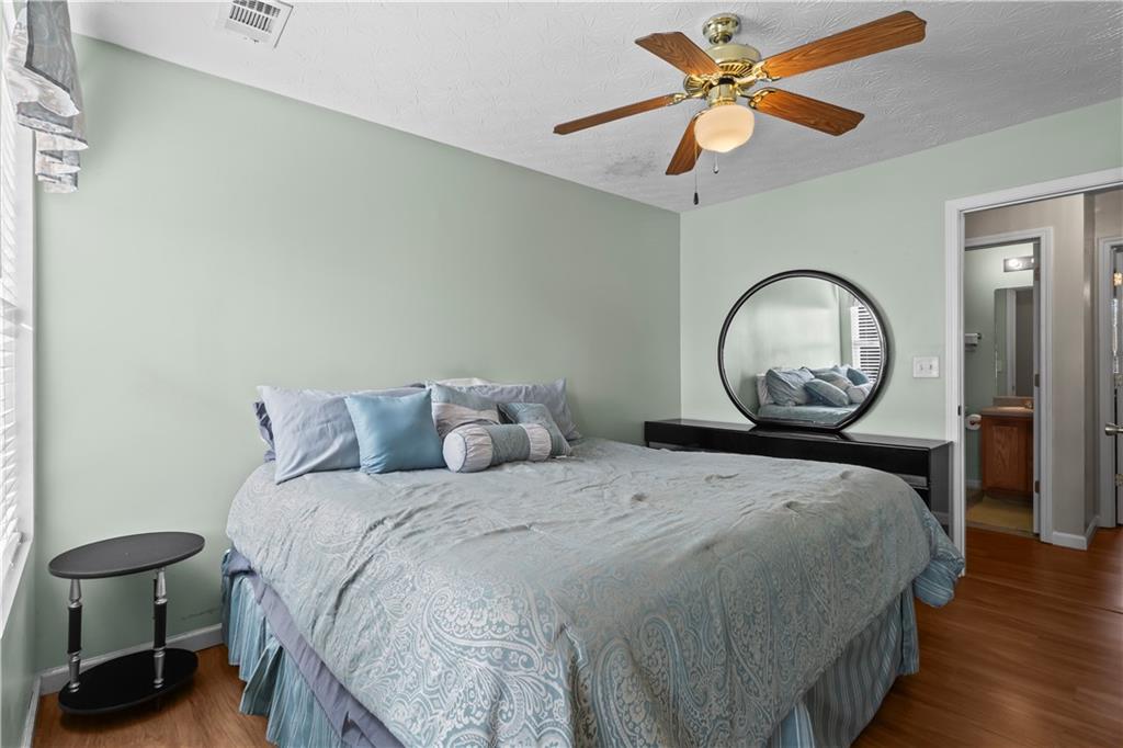 3000 Western Sunset Decatur, GA 30034 - Photo 21 of 37 a bedroom with a bed a dresser and chair