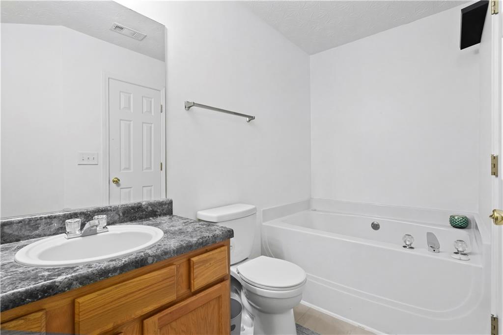 3000 Western Sunset Decatur, GA 30034 - Photo 30 of 37 a bathroom with a granite countertop sink toilet and bathtub