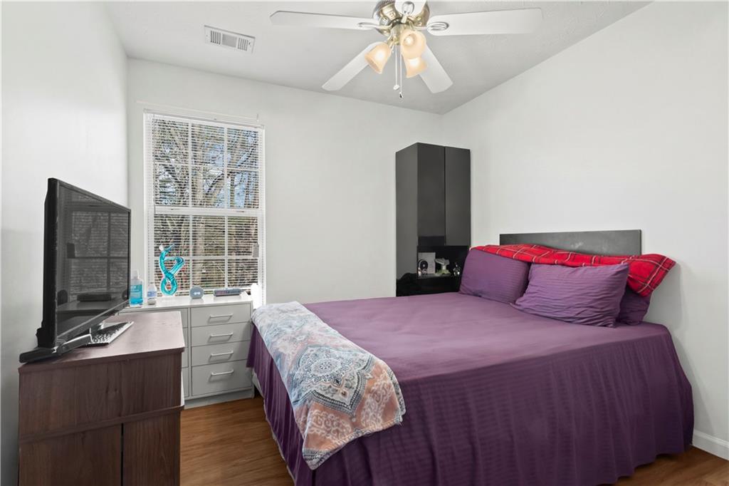 3000 Western Sunset Decatur, GA 30034 - Photo 34 of 37 a bedroom with a large bed and a flat tv screen on dresser