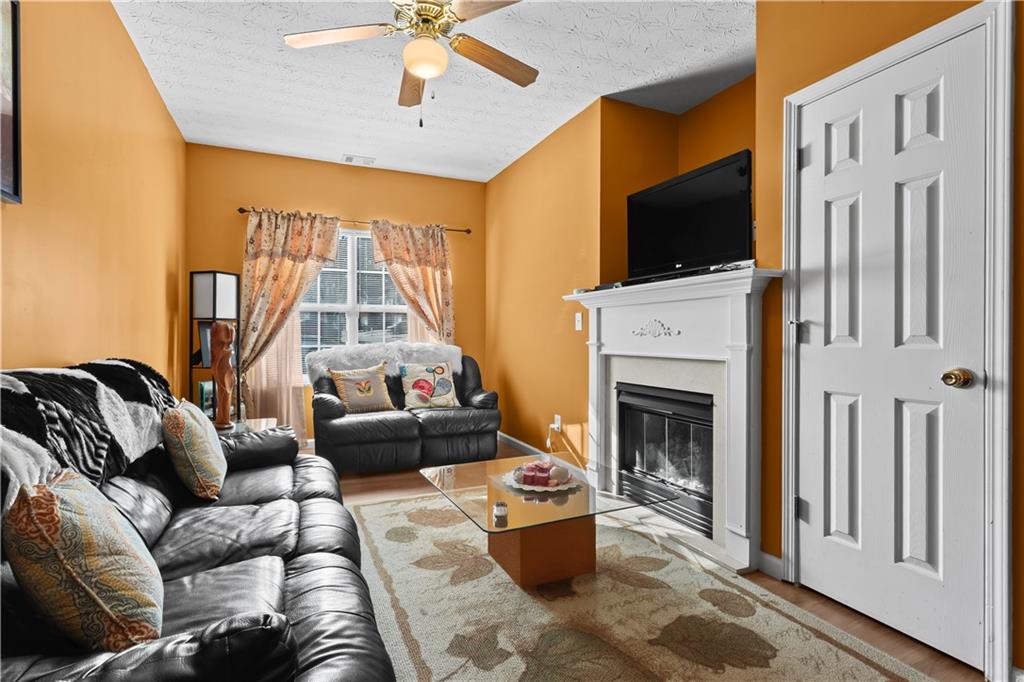 3000 Western Sunset Decatur, GA 30034 - Photo 7 of 37 a living room with furniture a fireplace and a flat screen tv