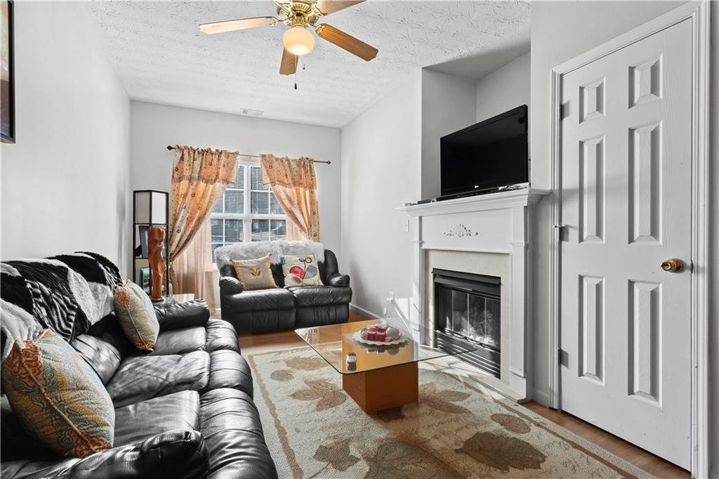 3000 Western Sunset Decatur, GA 30034 - Photo 8 of 37 a living room with furniture a fireplace and a flat screen tv