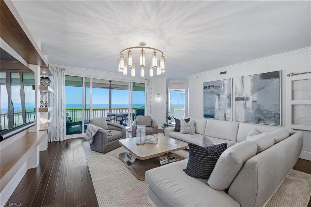 265 Indies Way, Unit 1004 Naples, FL 34110 - Photo 11 of 34 a living room with furniture and a large window