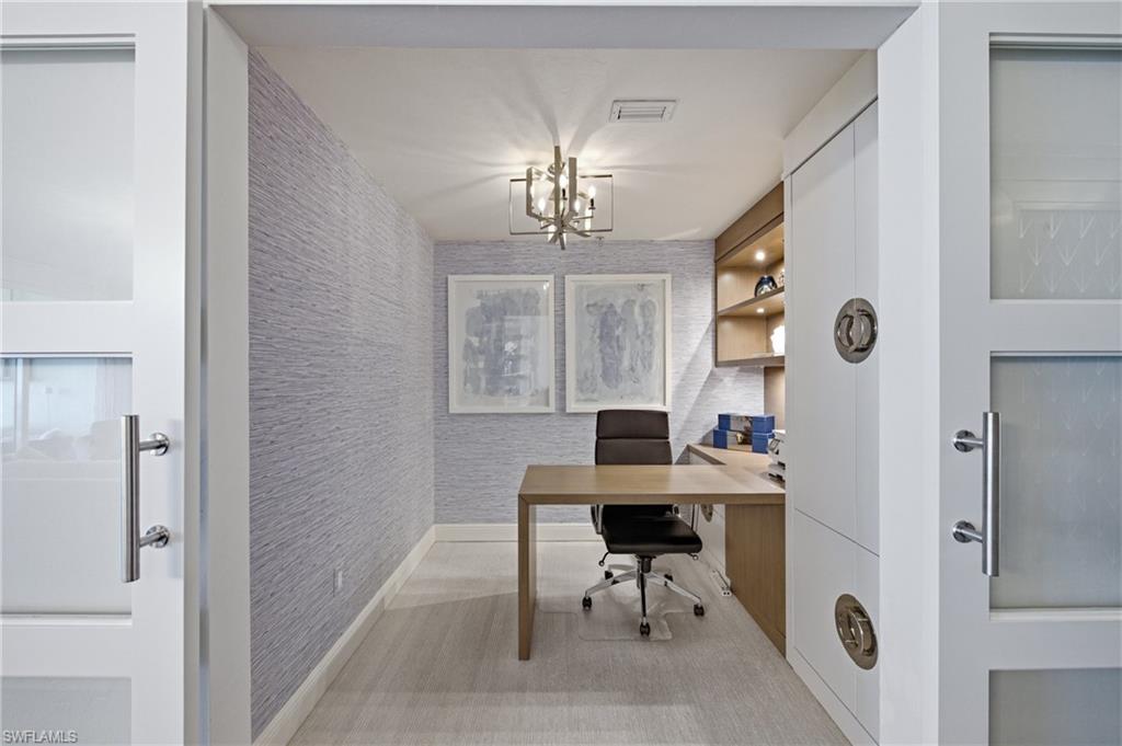 265 Indies Way, Unit 1004 Naples, FL 34110 - Photo 13 of 34 a workspace with a table and a window