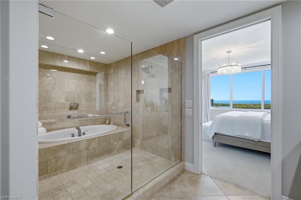 265 Indies Way, Unit 1004 Naples, FL 34110 - Photo 15 of 34 a bathroom with a tub shower and sink