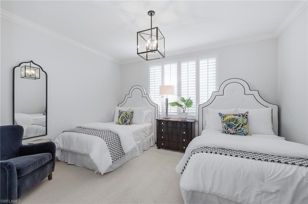 265 Indies Way, Unit 1004 Naples, FL 34110 - Photo 19 of 34 a bedroom with bed and window