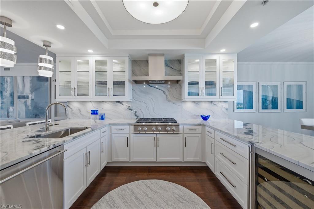 265 Indies Way, Unit 1004 Naples, FL 34110 - Photo 2 of 34 a kitchen with stainless steel appliances a sink stove and cabinets